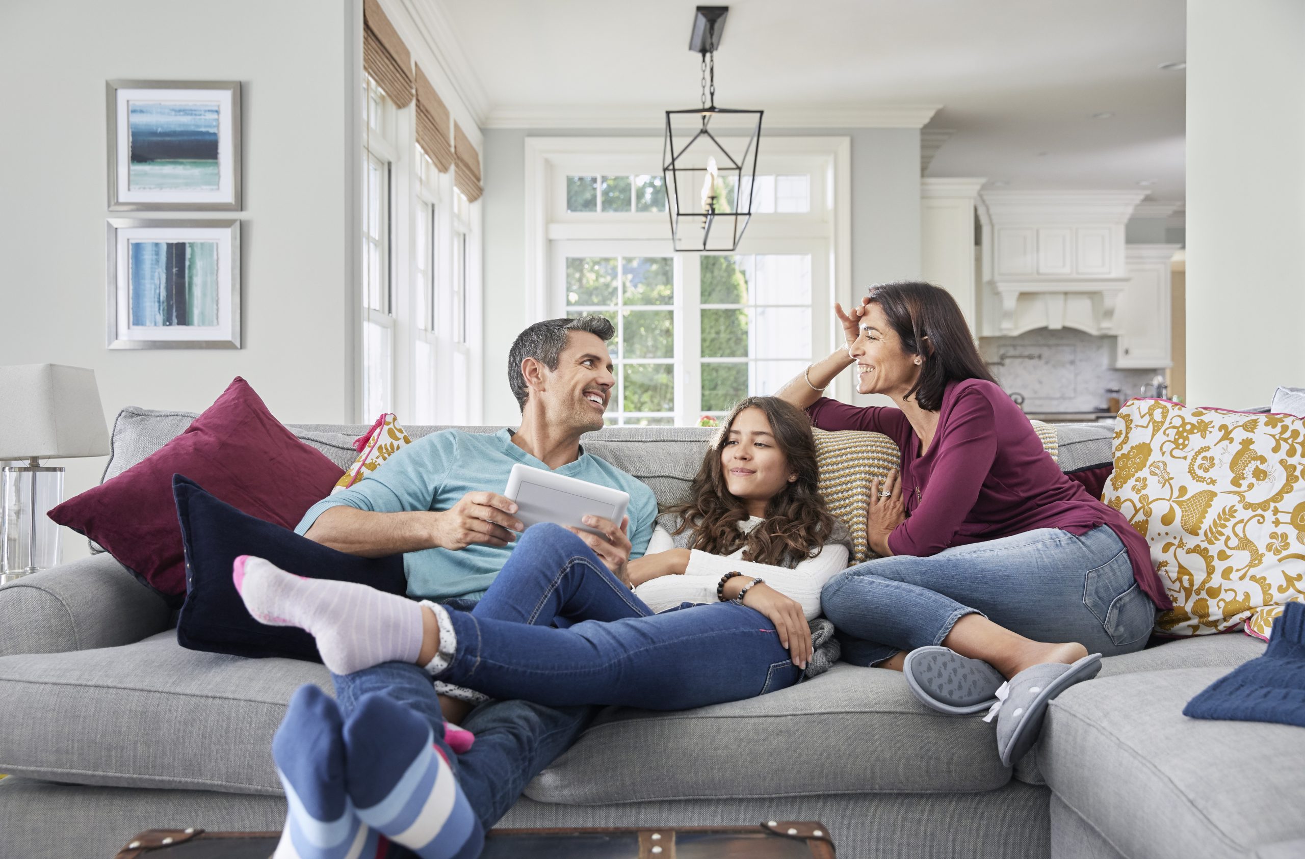 Family on couch with touchscreen